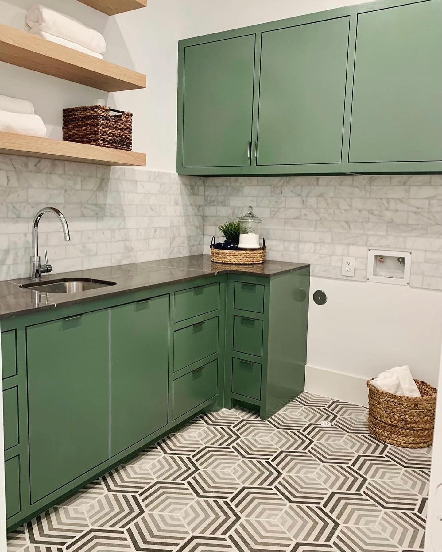 Friday Favorites 💚 Add some flair to your laundry room with a patterned tile floor. We love how this space turned out featuring our Bauhaus collection in the style “Arrow.” #emsertile #tgif